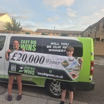 Winner holding cheque