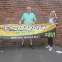 Winner holding cheque