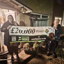 Winner holding cheque